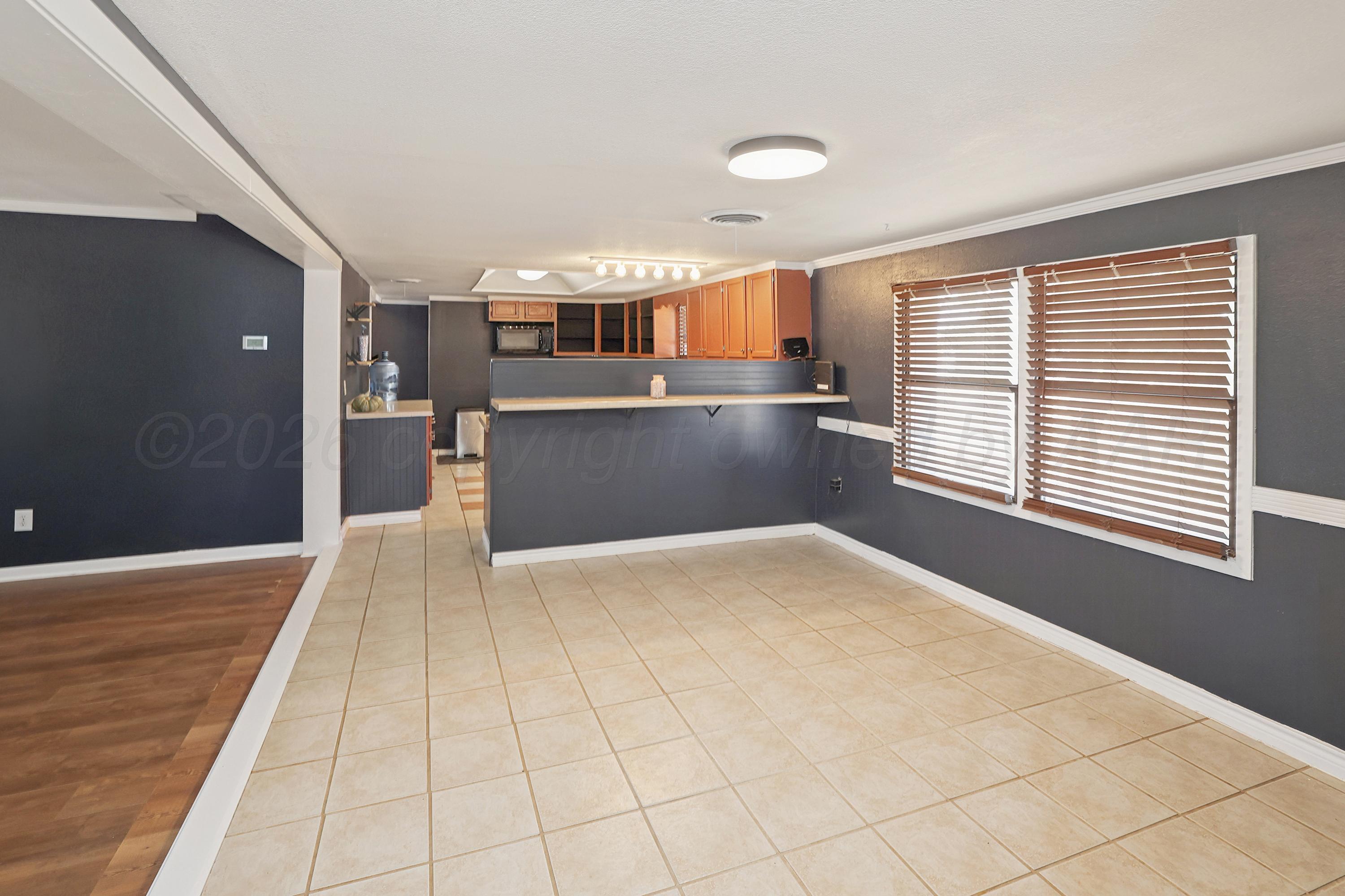 14200 Savannah Road Amarillo, TX 79118 - Photo 5 of 34 a view of empty room with wooden floor and fan