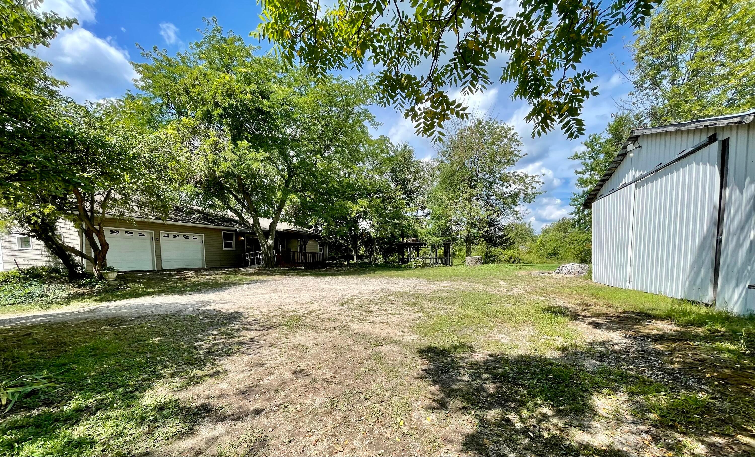 10671 Co Road East Liberty, OH 43319 - Photo 14 of 37 Parking area between house an barn