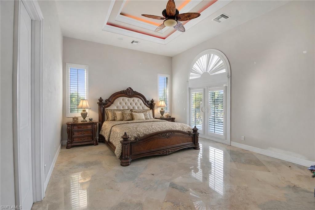 28 West Pelican Street Naples, FL 34113 - Photo 19 of 50 a bedroom with a bed next to a window