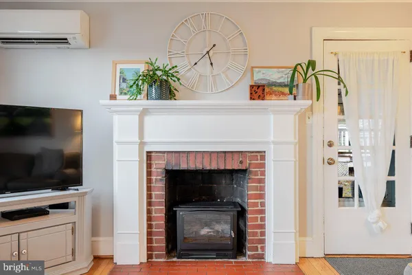 a living room with a baby crib furniture and a window