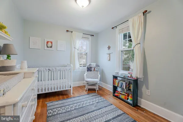 a kitchen with stainless steel appliances a microwave a stove and wooden floor