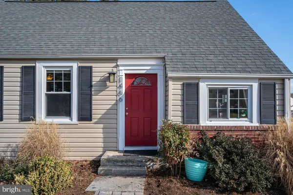 a view of a chair and table in backyard of the house