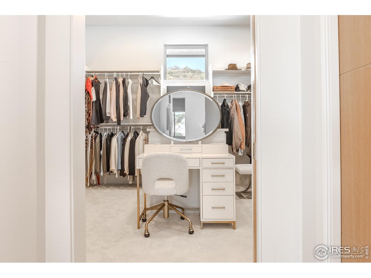7572 Raphael Lane Littleton, CO 80125 - Photo 23 of 50 The dressing closet rivals a boutique, fitted with custom storage and designer lighting worthy of a style influencer.