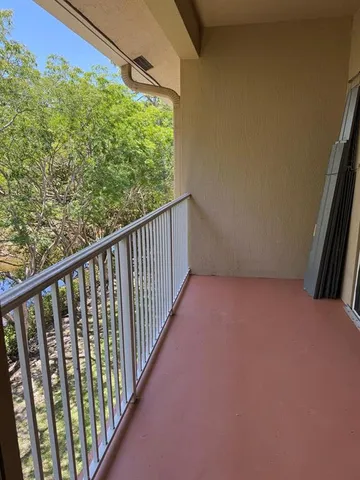 a kitchen with cabinets and a refrigerator