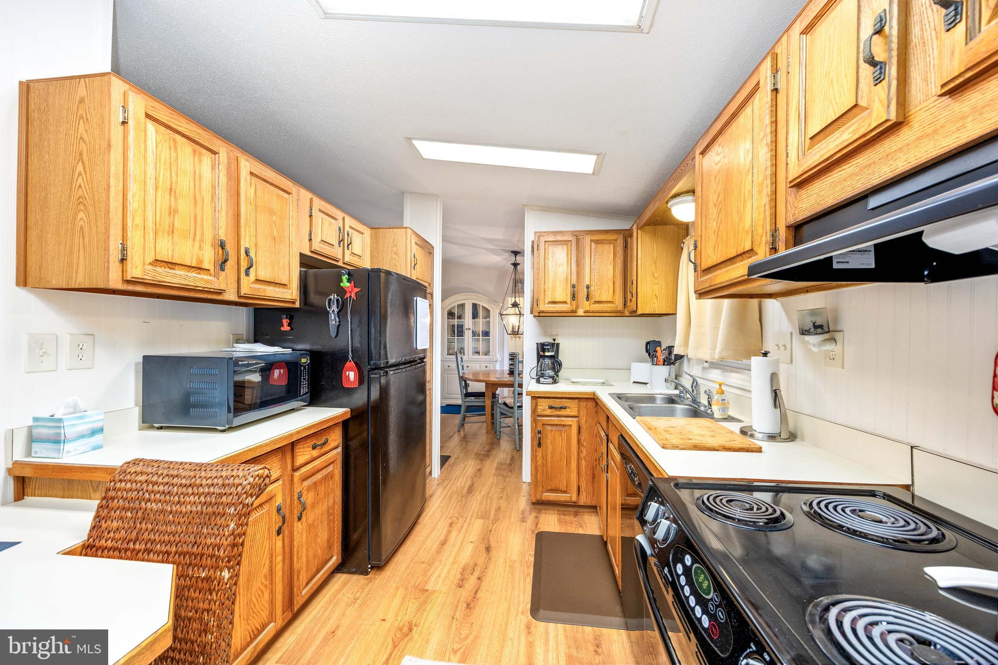 7940 Riverview Road Westover, MD 21871 - Photo 24 of 93 a kitchen with stainless steel appliances granite countertop a sink a stove and a wooden floors