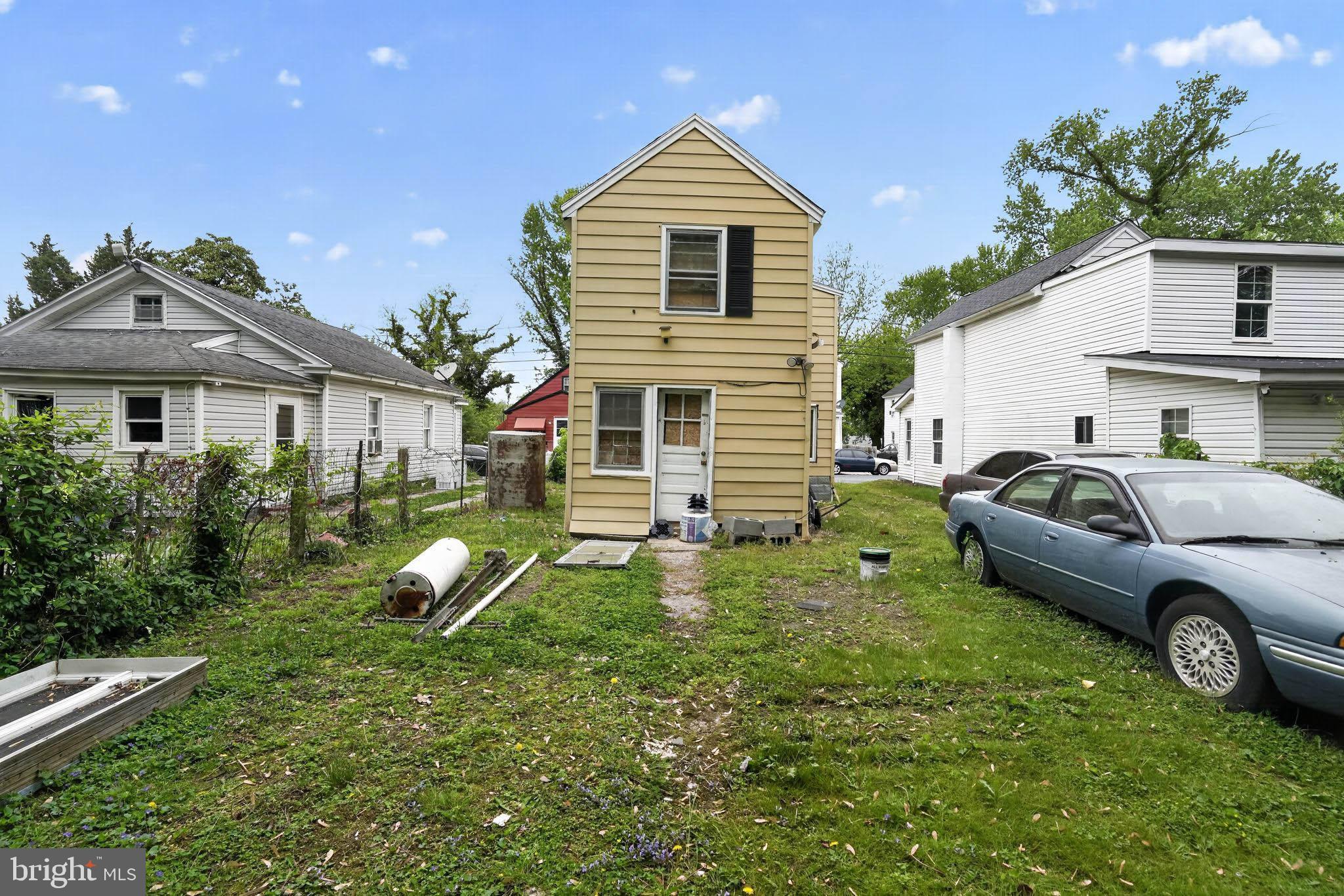 626 Douglas Street Cambridge, MD 21613 - Photo 12 of 15 a front view of a house with a yard and garage