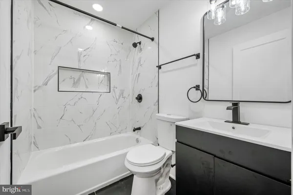 a bathroom with a sink a toilet and a bathtub