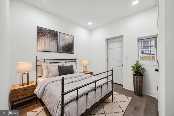 a bedroom with a bed and a potted plant