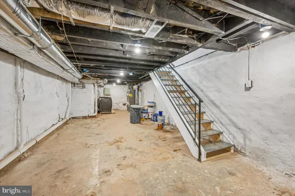 a backyard of a house with barbeque oven table and chairs