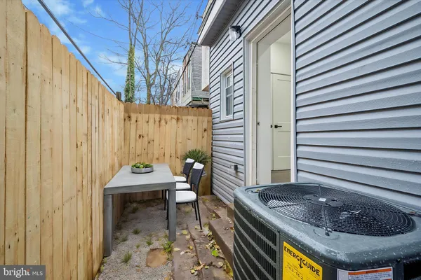 a house view with a backyard and a chair
