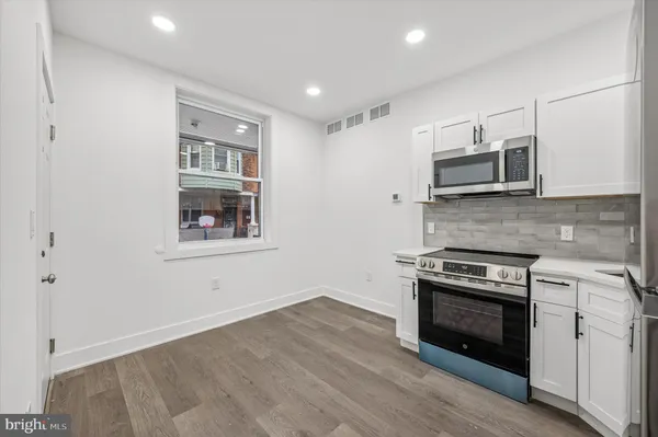 a kitchen with a stove and a microwave