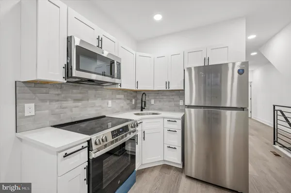 a kitchen with a stove microwave and refrigerator