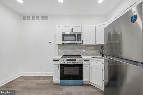a kitchen with a stove and a microwave