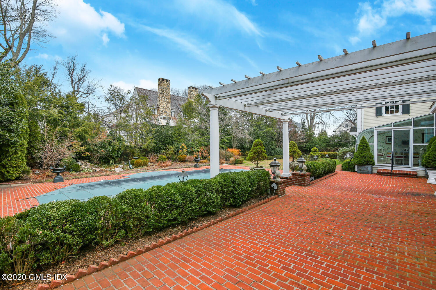 40 Willowmere Circle Riverside, CT 06878 - Photo 8 of 47 a view of a patio with a table and chairs under an umbrella