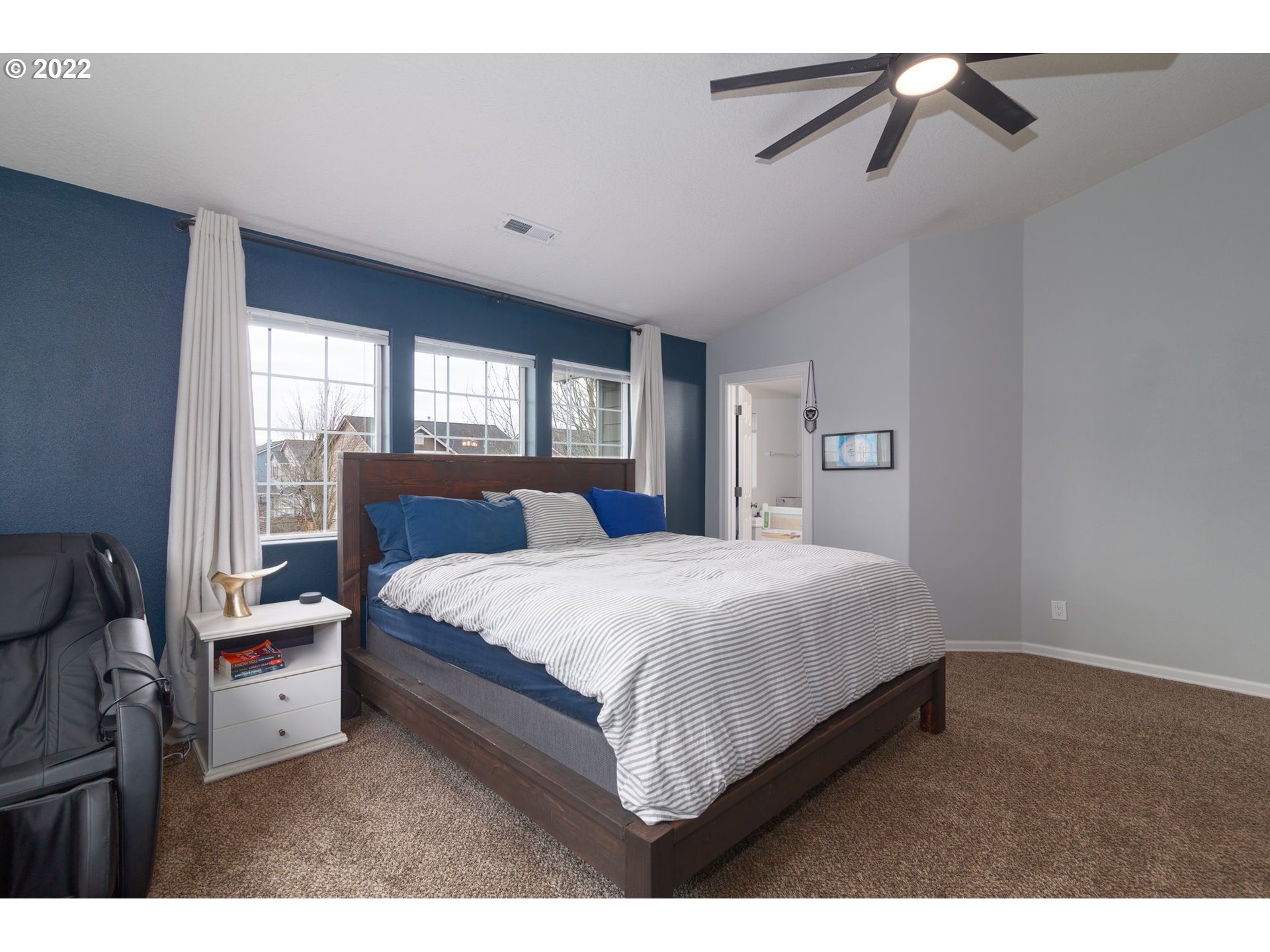 1310 Northeast 172nd Street Ridgefield, WA 98642 - Photo 24 of 32 a bedroom with a bed a window and a chandelier