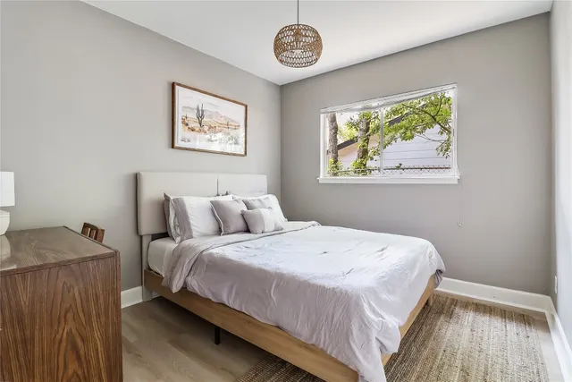 a bedroom with bed and a window