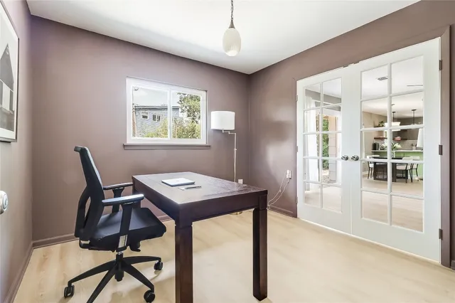 a view of a workspace with furniture and window