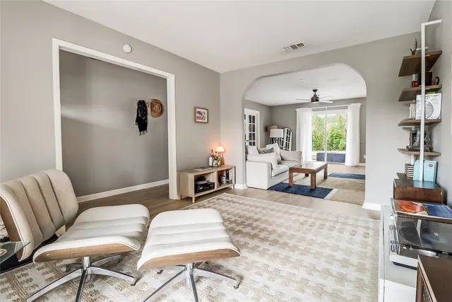 a living room with furniture a rug and a large window