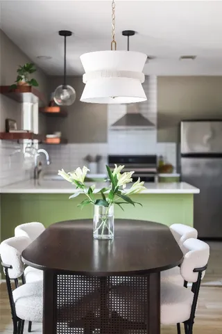 a dining room with furniture and a potted plant