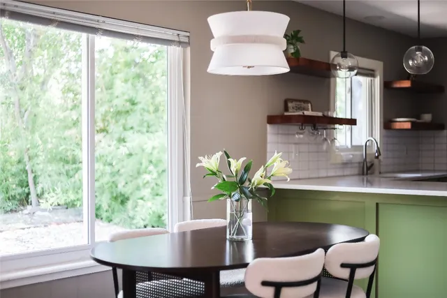 a dining room with furniture and a potted plant