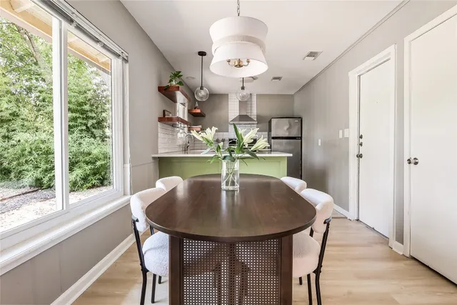 a dining room with furniture and window