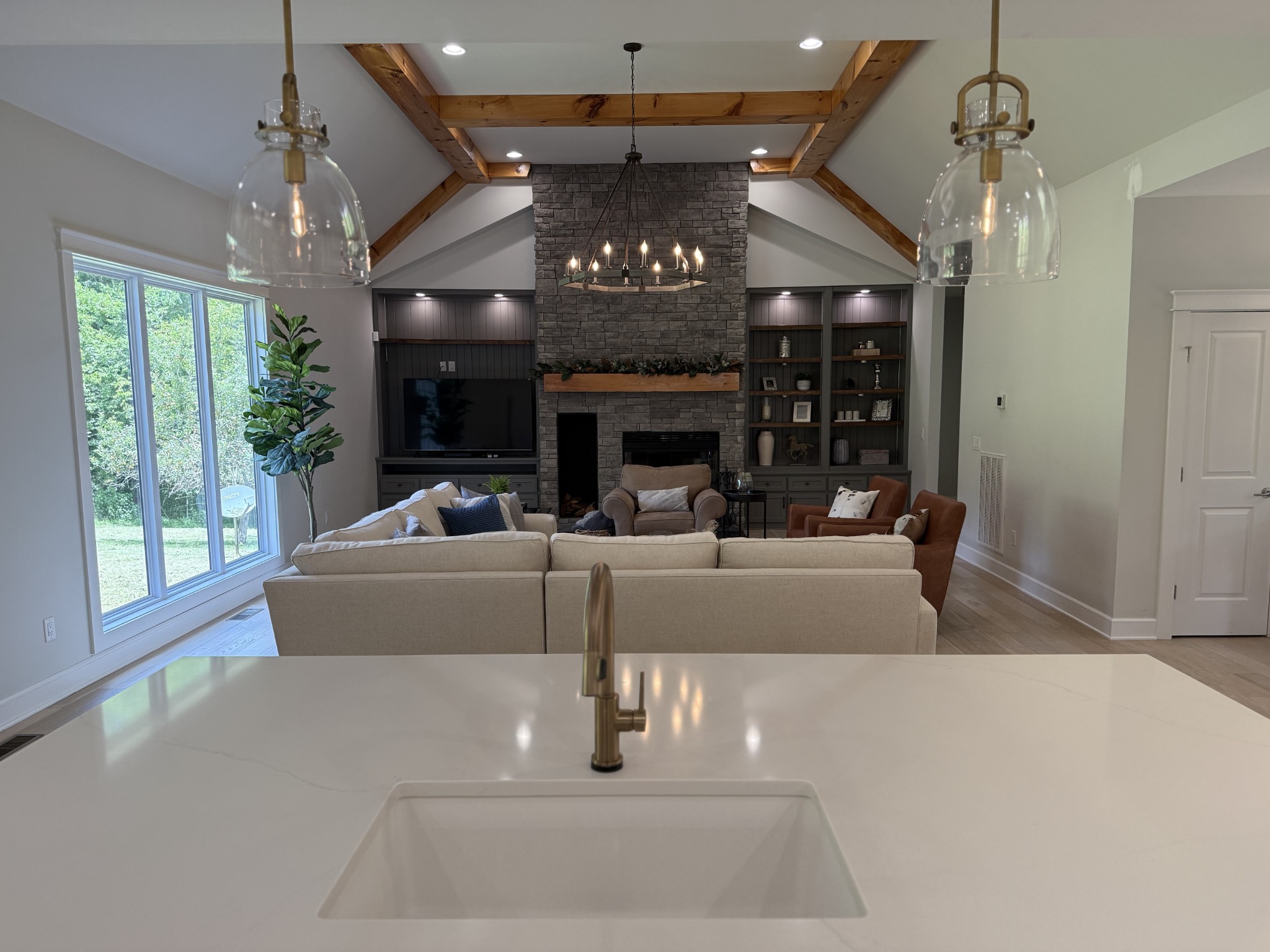 2145 Honey Prong Road Hartsville, TN 37074 - Photo 14 of 99 a living room with couch a chandelier and a fireplace