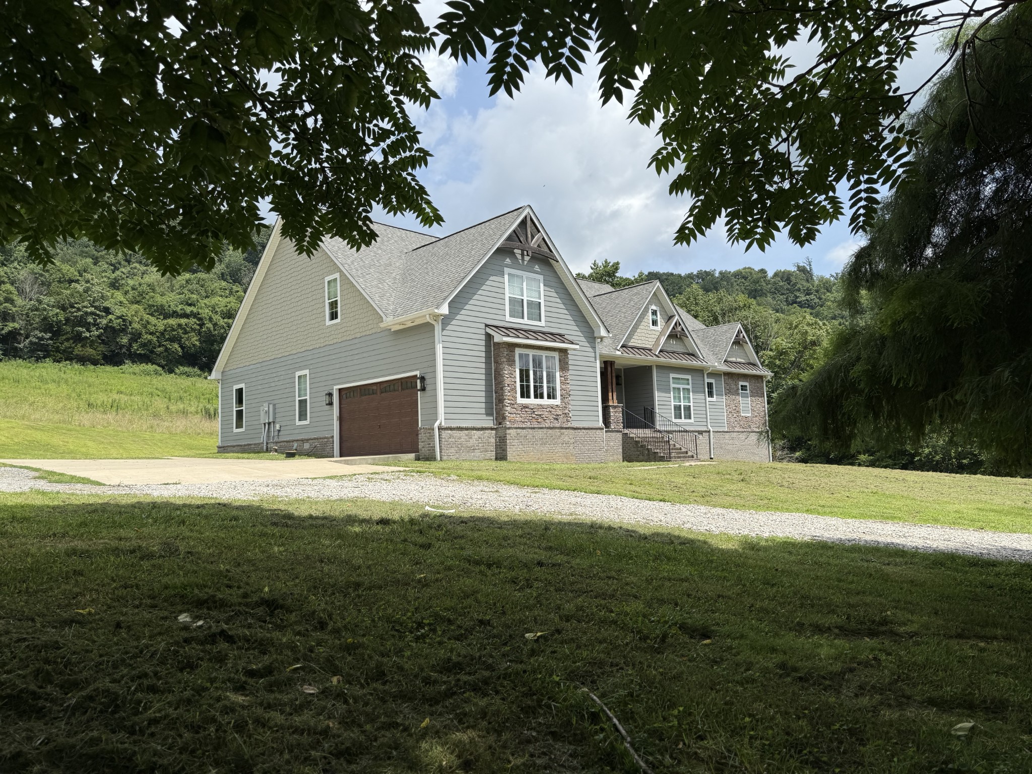 2145 Honey Prong Road Hartsville, TN 37074 - Photo 5 of 99 a front view of a house with a garden and trees