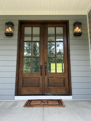 a living room with furniture kitchen view and a chandelier