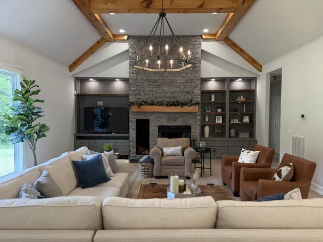 a living room with couch a chandelier and a fireplace