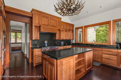 a kitchen with sink a window and cabinets