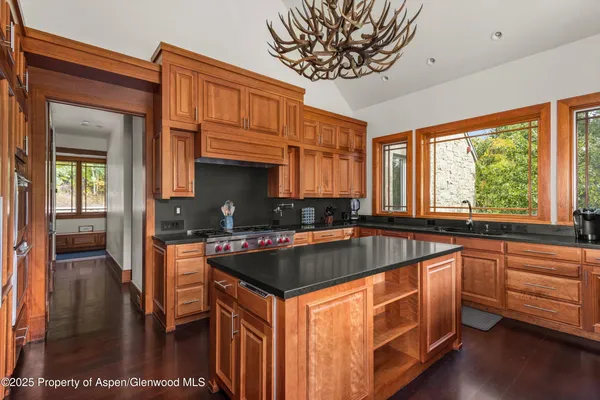 a kitchen with sink a window and cabinets