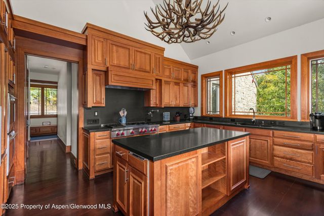 a kitchen with sink a window and cabinets