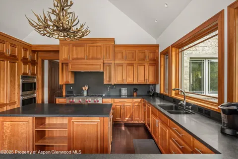 a spacious bedroom with a bed and glass windows