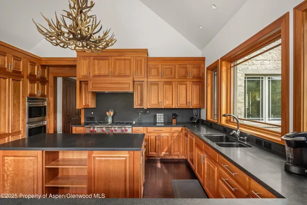 a spacious bedroom with a bed and glass windows