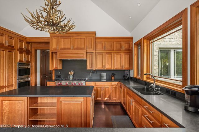 a spacious bedroom with a bed and glass windows