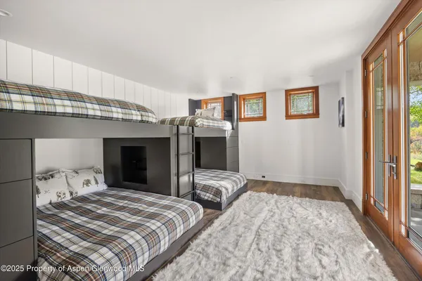 a view of a road with a yard and a large tree