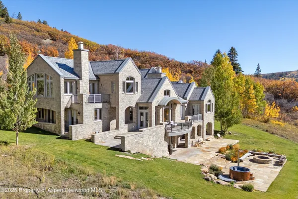 a backyard of a house with yard and outdoor seating