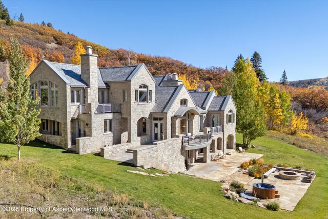 a backyard of a house with yard and outdoor seating