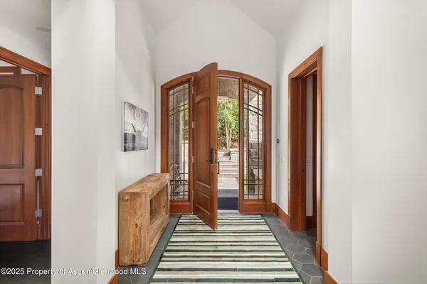 a living room with furniture and large windows