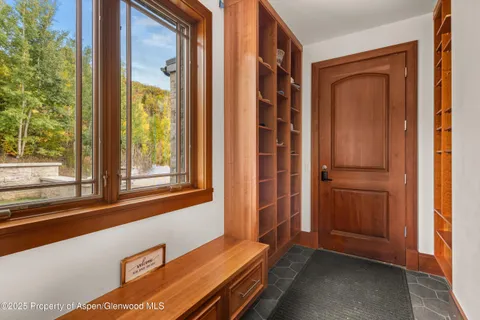 a living room with furniture large window and flat screen tv