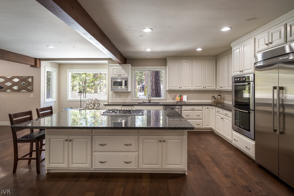 818 Ophir Peak Road Incline Village, NV 89451 - Photo 6 of 23 a kitchen with granite countertop white cabinets and stainless steel appliances