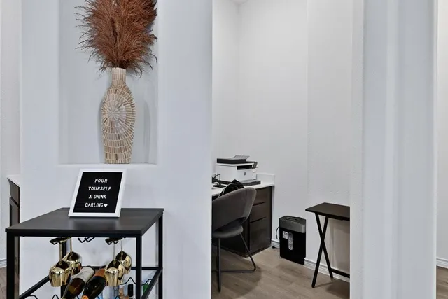 a view of workspace filled with furniture and wooden floor