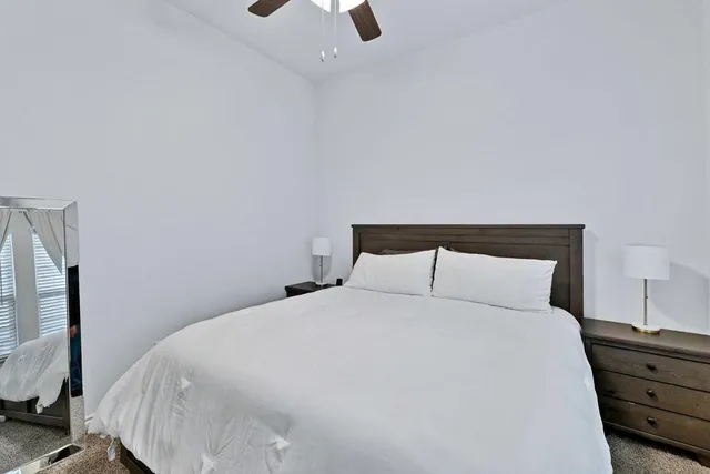 a large bed sitting in a bedroom next to a window with tv