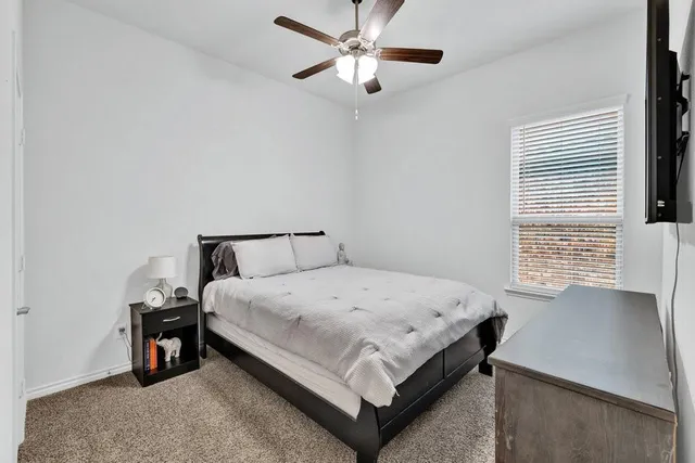 a bed room with a bed and a night stand