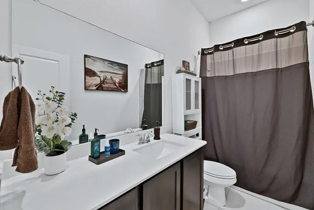 a bathroom with a sink toilet and shower