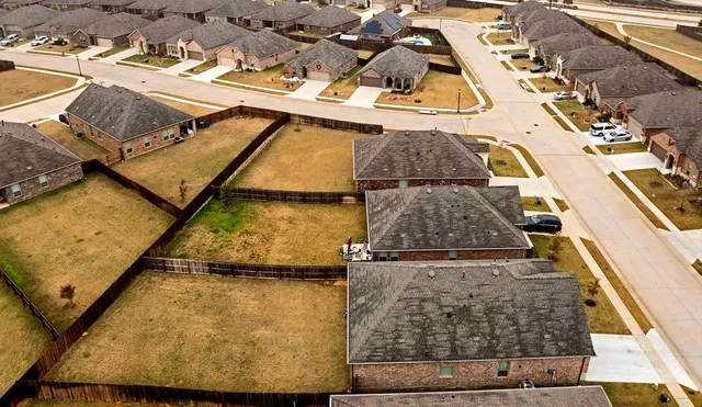 an aerial view of residential houses with outdoor space