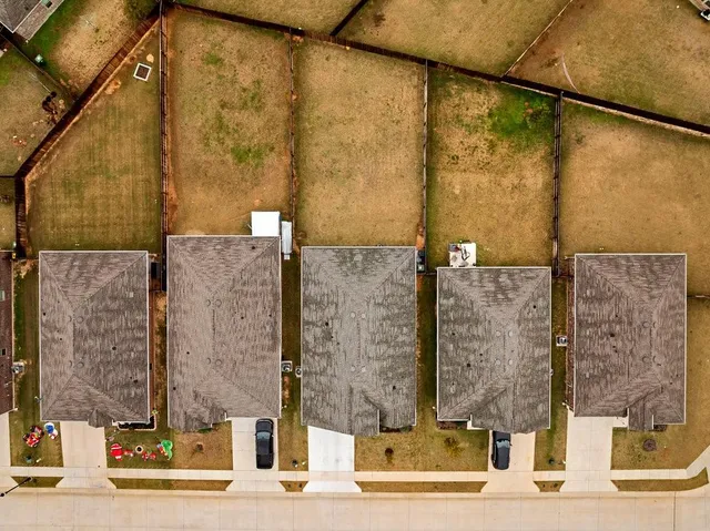 an aerial view of a house with swimming pool
