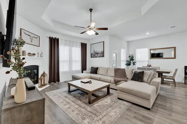 a living room with furniture a table and a chandelier