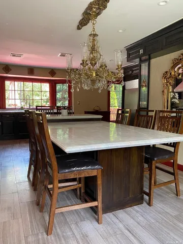 a dining room with wooden floor a table and chairs