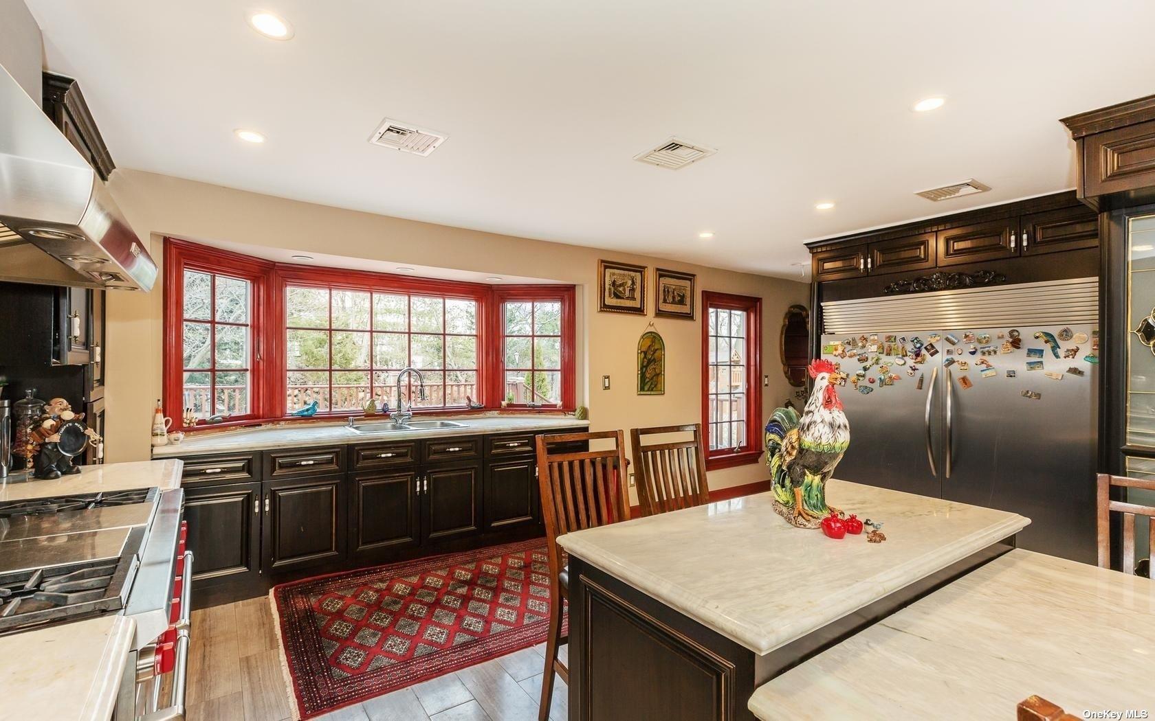 7 Old Field Road Setauket, NY 11733 - Photo 15 of 33 a large kitchen with stainless steel appliances granite countertop a stove a sink and a refrigerator